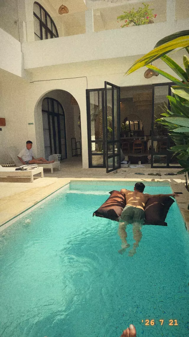 A friend floating in the villa pool